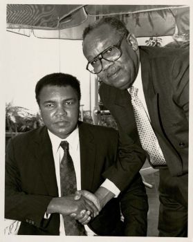 Brad Pye Jr. shaking hands with Muhammad Ali