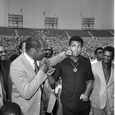 Tom Bradley throwing a playful punch at Muhammad Ali during the Freedom Football Classic, Los Angeles, 1973. Harry Adams Collection. ID: 93.01.HA.N120.B25.11.51.08