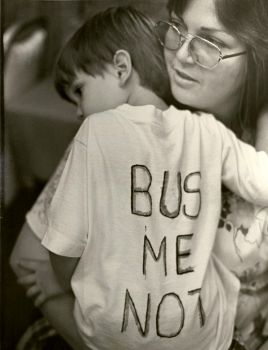 A mother holds her son at a BUSTOP campaign rally