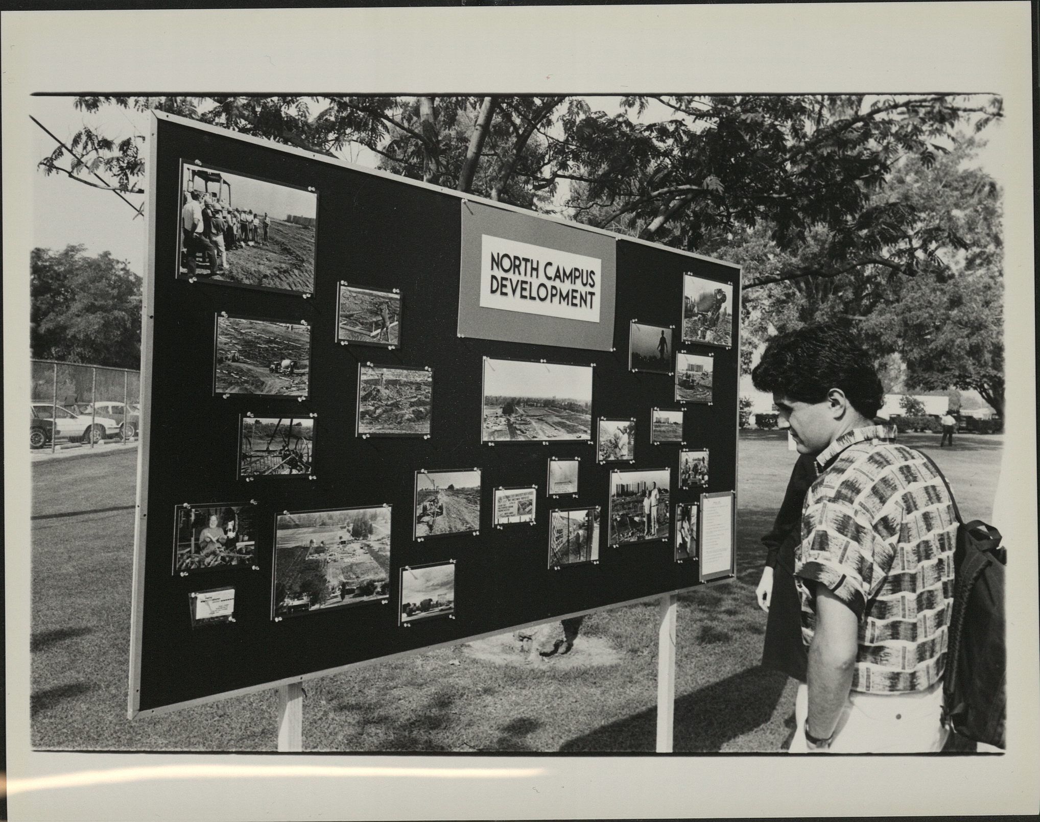 A photograph of a student looking at a bulletin board about North Campus construction, and photos of construction progress.