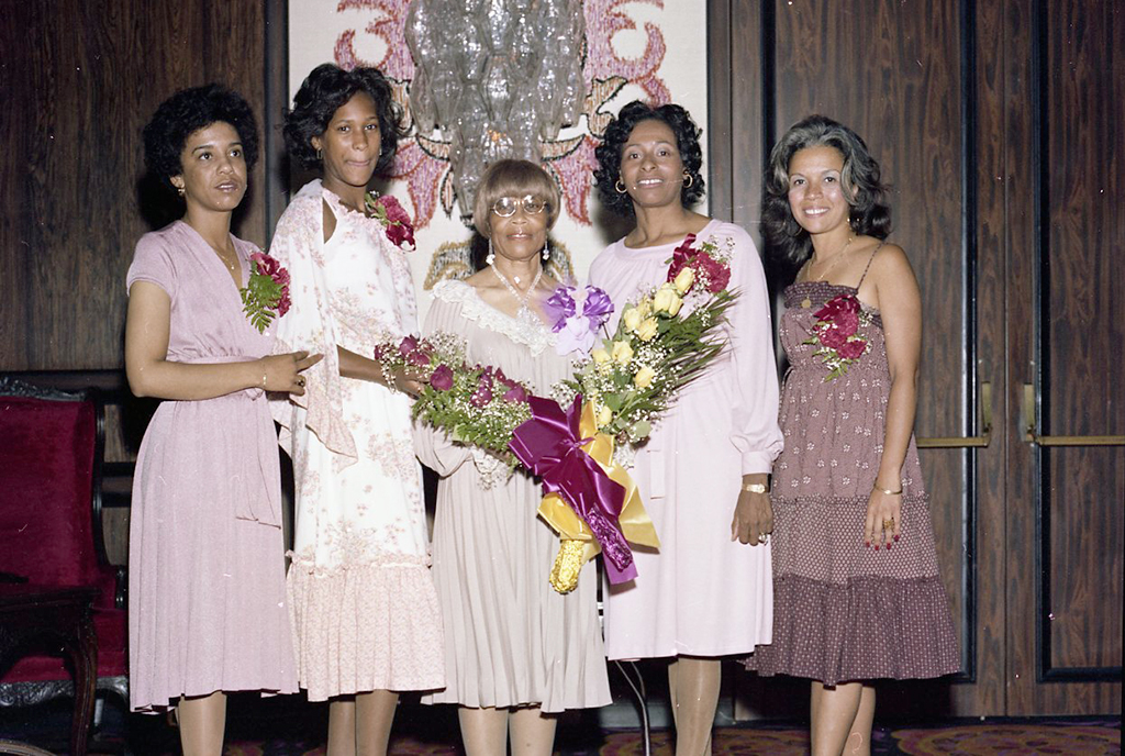 7.	Norma Madkim posing with guests at her retirement luncheon, 1978, Jack Davis Photograph Collection, Box 17 Folder 6.