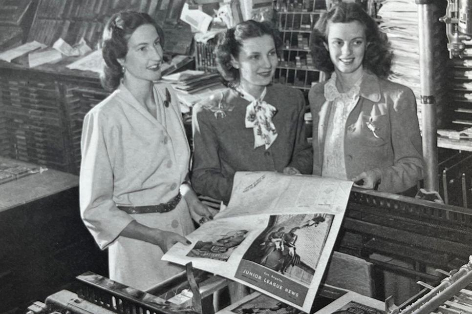 Junior League members holding an issue of the Los Angeles Junior League News