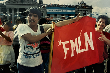 Image Selected from Collection by Student Assistant Veronica: Salvadoran men show off their FMLN flag in front of the National Palace in San Salvador, El Salvador, 1994.