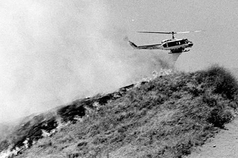 Los Angeles Fire Department helicopter dropping water on a brush fire in Sylmar, 1980, Robert and Betty Franklin Collection, RBF00 025