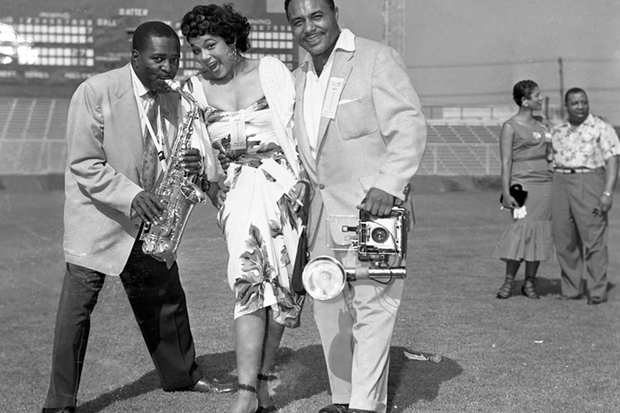 Bandleader and musician Louis Jordan (left), unidentified woman, and photographer Harry Adams (right) at the Cavalcade of Jazz. Harry Adams Collection. 93.01.HA.N45.B34.133