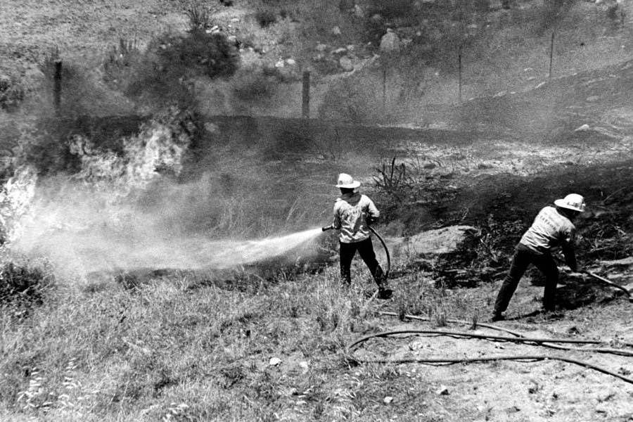 Fire fighters from Fire Station 75 work to extinguish flames in Sylmar, June 19, 1980