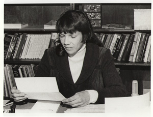 Women sitting at desk and reading a letter