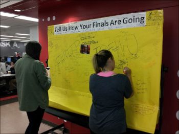 students writing on board at csun university library