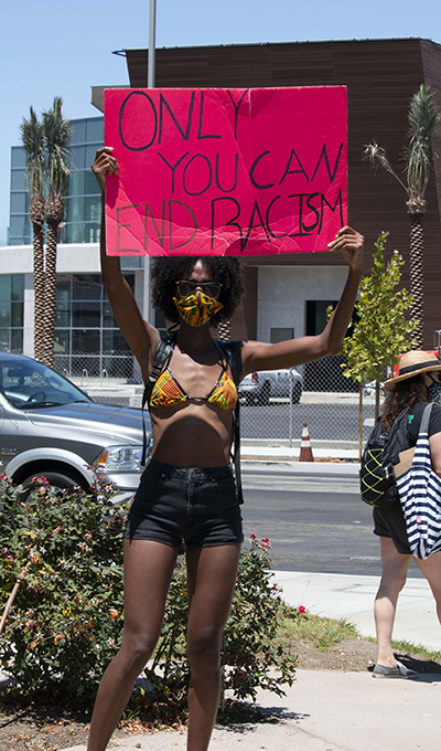 An unidentified individual holds a poster that reads "Only You Can End Racism" during a gathering for Breonna Taylor Marina Del Rey, 2020, KRT.D.B1.12.3761
