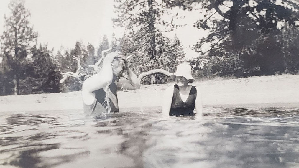 H.M and his wife enjoying a swim at the lake, Johnson Family Echo Lake Photograph Collection