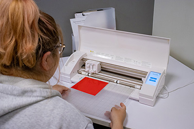 Student using a vinyl cutter