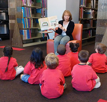 Nancy Davidson reading to children at the Teacher Curriculum Center