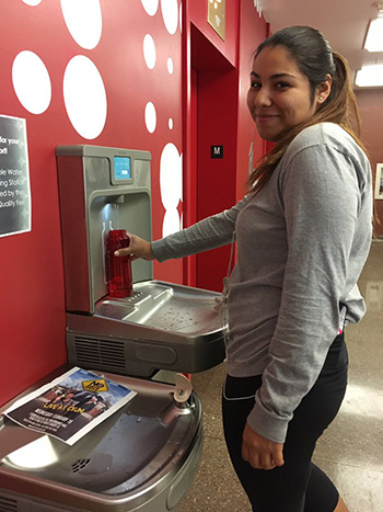 CSUN Student Jasmin Morfin using the refillable water bottle station.
