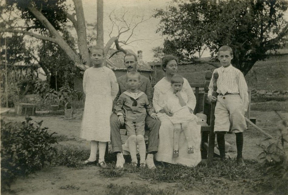 "The family in the back yard, Ruth, Mr. Tharp, Bob, Mrs. Tharp with Barbara on her lap, Gil," Robert and Eva Tharp Collection