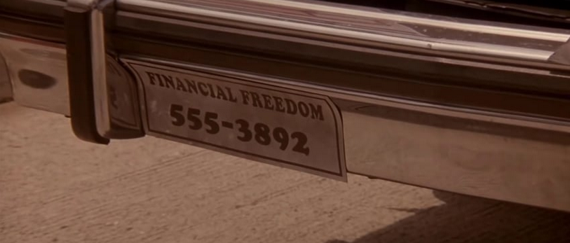Sticker on a car's rear bumper that reads Financial Freedom 555-3892.